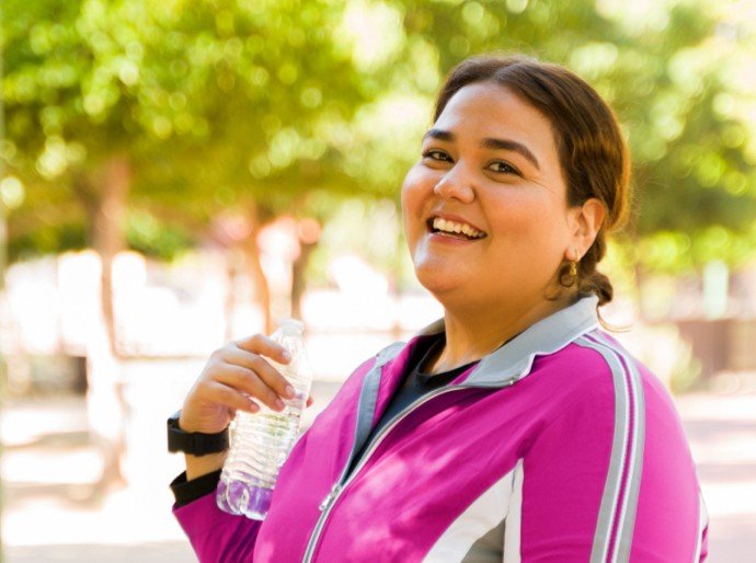 Woman with water bottle and pink jacket
