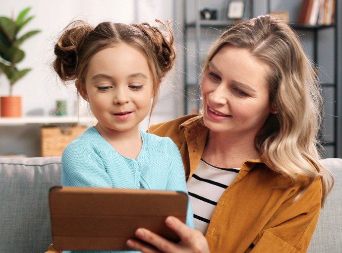 Mom and daughter looking at tablet