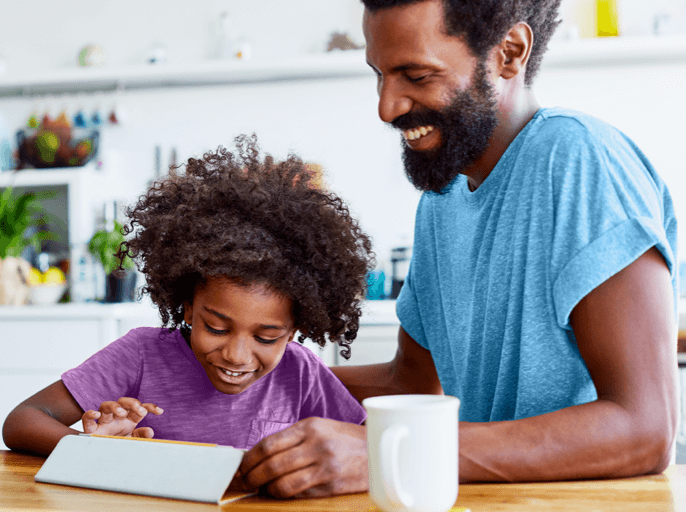 Father and daughter looking at tablet